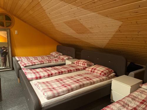a row of beds sitting in a room at Arctic Skyview Retreat in Tromso - with parking in Tromsø