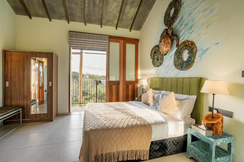 a bedroom with a bed and a balcony at O2 Villas Yala in Yala