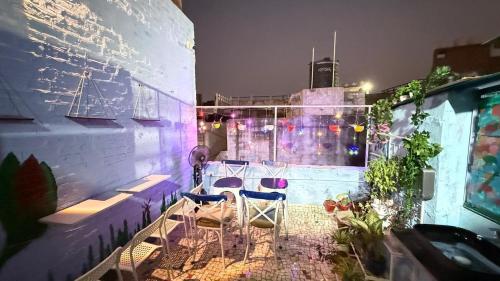 a room with chairs and a wall with purple lights at Ghumakkad Jodhpur in Jodhpur