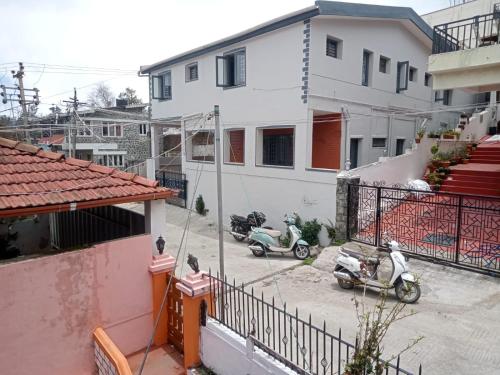 an aerial view of two scooters parked outside a building at Kodai ARYASREE in Kodaikānāl