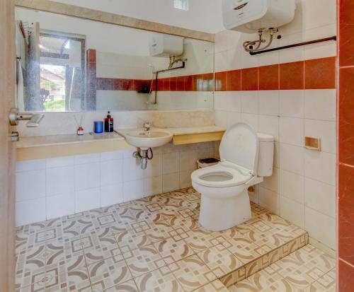a bathroom with a toilet and a sink at Villa Pinokio W BBQ & Backyard in Bandung