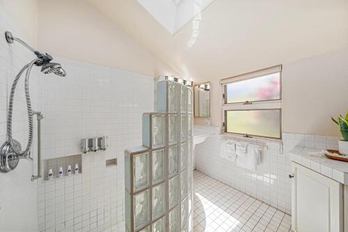 a white bathroom with a shower and a sink at International Colony Club 43 · ICC 43 Spacious 2BD Cottage Walk in Lahaina
