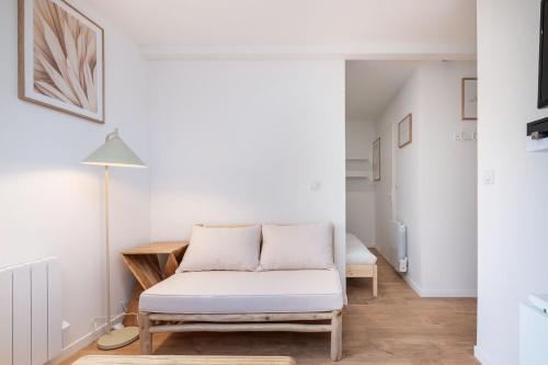 a living room with a couch and a table at Apartment Perron - Cozy 2 people - Oullins in Oullins