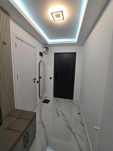a bathroom with a large marble floor and a door at Blue sky in Itʼkhvisi