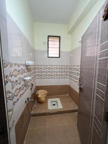 y baño con aseo y ventana. en Happy living 2, en Vijayawada