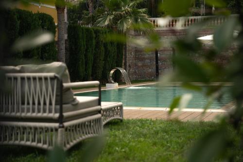 a bench sitting next to a swimming pool at Alaxia Exclusive Apartments in Alassio