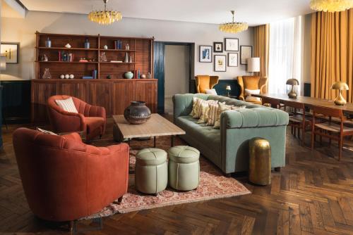 a living room with a couch and chairs and a table at Native Hyde Park in London