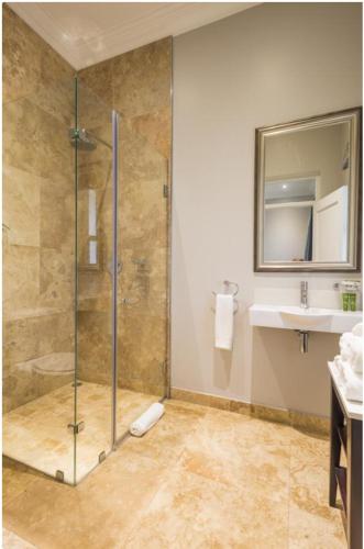 a bathroom with a shower and a sink at Luxe Avondale Boutique Hotel in Durban