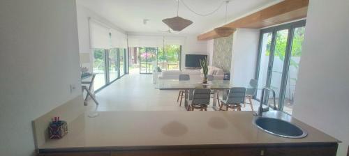 a kitchen and living room with a sink in a house at Villa golf de Montchoisy in Mont Choisy