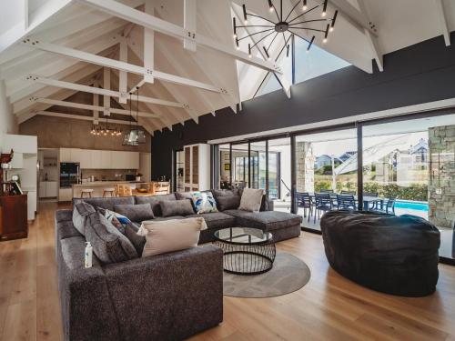 a living room with two couches and a kitchen at Moorlands Manor in George