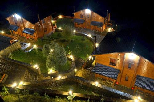 an aerial view of a building at night with lights at Xilino Horio in Chrysomiléa