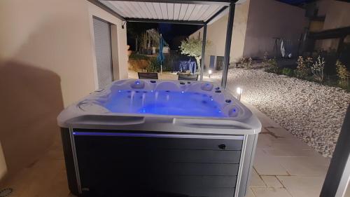 a jacuzzi tub in the middle of a yard at Havre de paix en Drôme villa moderne climatisée - jacuzzi "la maison d'à côté" in Chatuzange-le-Goubet