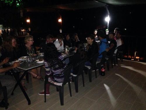 a group of people sitting at tables at a restaurant at night at Hotel Sema in Patara