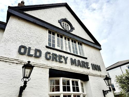 an old grey maze building with a clock on it at Old Grey Mare in York