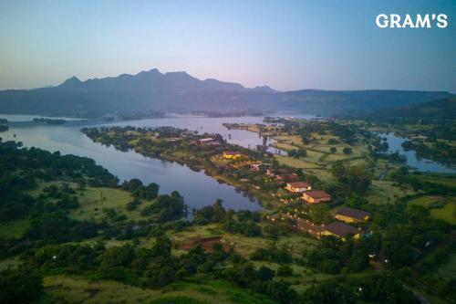 an aerial view of a town next to a river at Gram's at Shivom, Pawna Lake in Lonavala