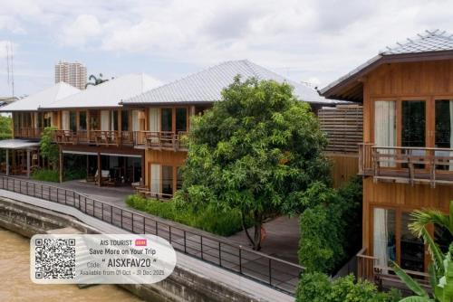 a row of houses with a sign in front of them at Chann Bangkok Noi in Bangkok