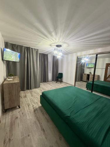 a bedroom with a large green bed and a mirror at Studio Bella Centru 26 in Craiova