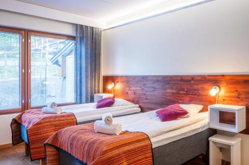 a hotel room with two beds and a window at Hotel Arctic Zone in Ruka