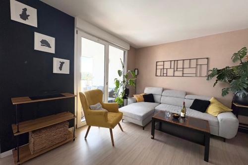 a living room with a couch and a table at Le Beauvoir a chic haven near Strasbourg in Strasbourg