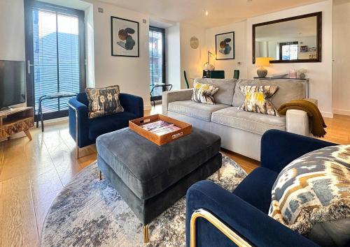 a living room with a couch and chairs and a tv at Westminster Luxury Two Bed Two Bath with Air-Con in London