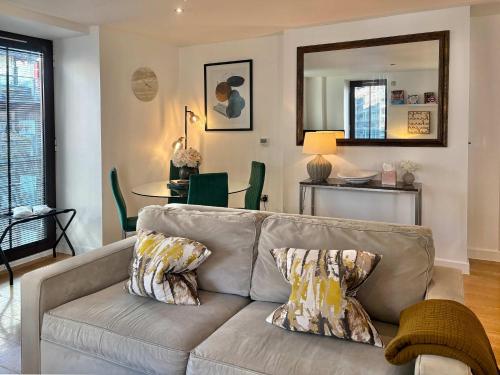 a living room with a couch and a table at Westminster Luxury Two Bed Two Bath with Air-Con in London