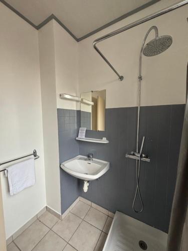 a bathroom with a sink and a shower at Happy Break in Saint-Michel-en-lʼHerm