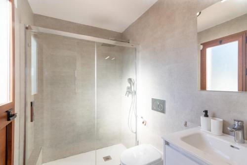a bathroom with a shower and a toilet and a sink at Villa Elisa in Nerja