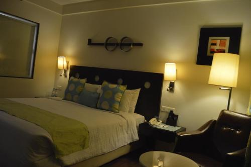 a hotel room with a bed and a chair at Fortune Inn Sree Kanya, Visakhapatnam - Member ITC Hotels' Group in Visakhapatnam