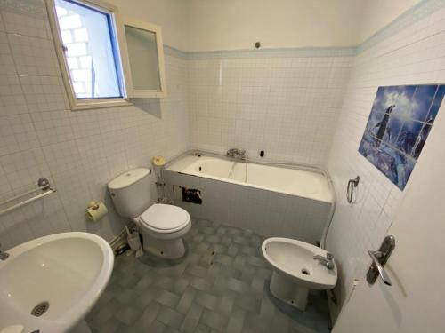 a bathroom with a toilet and a tub and a sink at Bardo centre in Tunis