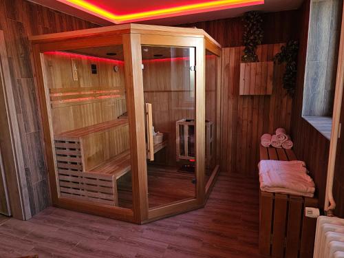 a wooden sauna with a glass door in a room at Hotel Gól Prostějov in Prostějov