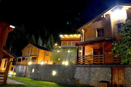 a house with lights on the side of it at night at Xilino Horio in Chrysomiléa