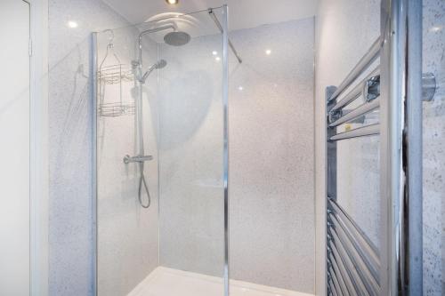 a shower with a glass door in a bathroom at The Screes Apartment - Short stroll from Wastwater in Nether Wasdale