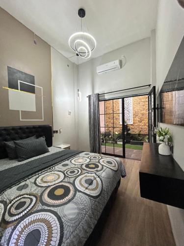 a bedroom with a large bed and a table at Java Hostel 2 in Lumajang