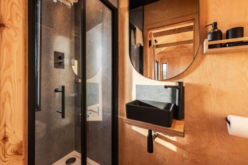 a bathroom with a shower and a mirror at Cabins at Bogee Farm in Saint Ervan