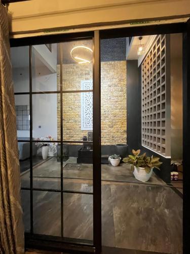 a room with a large glass door with plants at Java Hostel 2 in Lumajang