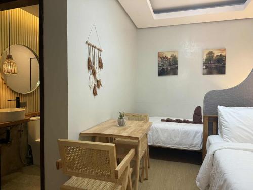 a bedroom with a bed and a table in a room at Inngo Tourist Inn in El Nido