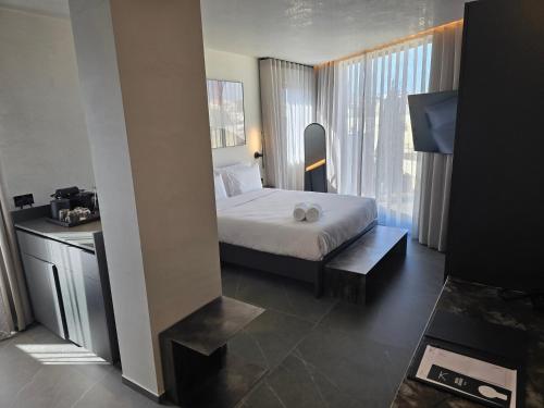 a bedroom with a bed and a large window at Thirty Three Boutique -Adults Only By K Hotels in St Julian's