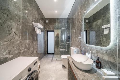 a bathroom with a sink and a toilet and a tub at Oasis Pandawa 10A - Private Luxury Awaits - Newly Built Villa with Pool in Ungasan