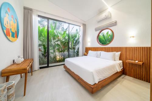 a bedroom with a bed and a large window at Oasis Pandawa 10A - Private Luxury Awaits - Newly Built Villa with Pool in Ungasan