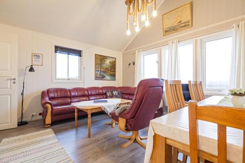 a living room with a couch and a table at Sjøstrand Rorbuer in Ballstad