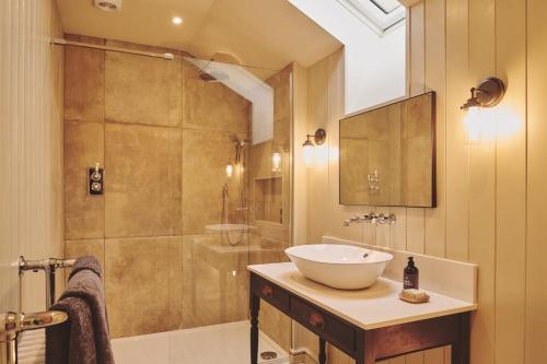a bathroom with a sink and a shower at Mill House in Trefeglwys