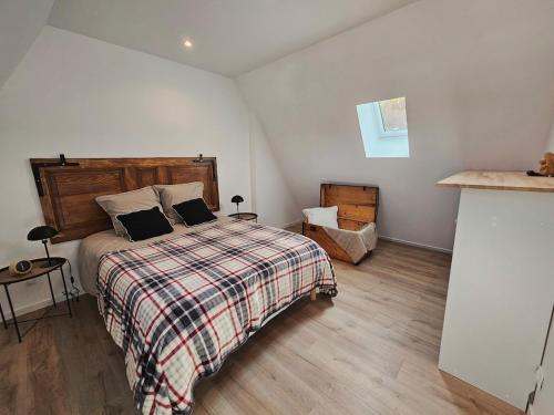 a bedroom with a bed with two pillows on it at Gîte a la source in Bergholtz-Zell