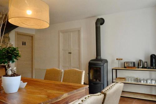 a dining room with a wooden table and a wood stove at Ca' Marì Torricelle Bed&Breakfast in Verona