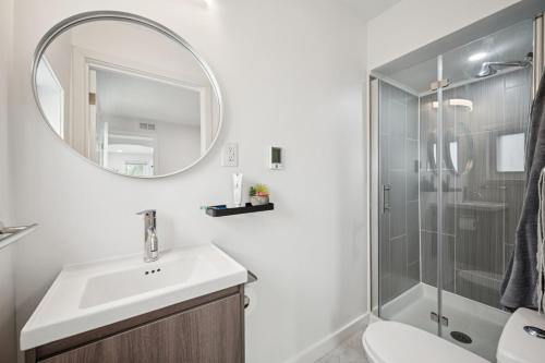 a bathroom with a sink and a shower with a mirror at ModPod 4 