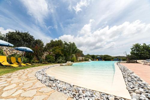 a swimming pool at a resort with a beach at Hotel Relais Pian delle Starze in Marina di Camerota