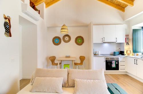 a living room with a couch and a table at Casa da Vila in Vila Real de Santo António