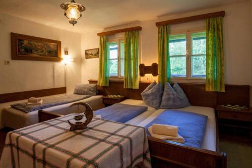 a bedroom with two beds with green curtains at Mountain-view Cottage Sleeps 15 -Balcony -Pets Ok in Bicheln