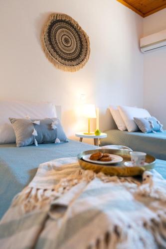 a room with a bed with a tray of food on it at Villas Mina and Studios in Gennadi