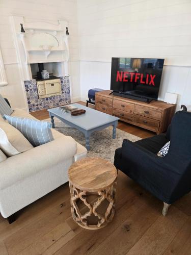 a living room with a couch and a table at CERULEAN HOUSE - Iconic Renovated Period Home - Close to Everything in Bendigo