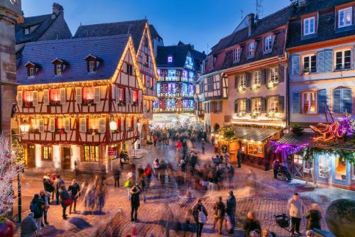 a group of people walking around a street with buildings at le petit cosy terrasse et spa in Petersbach